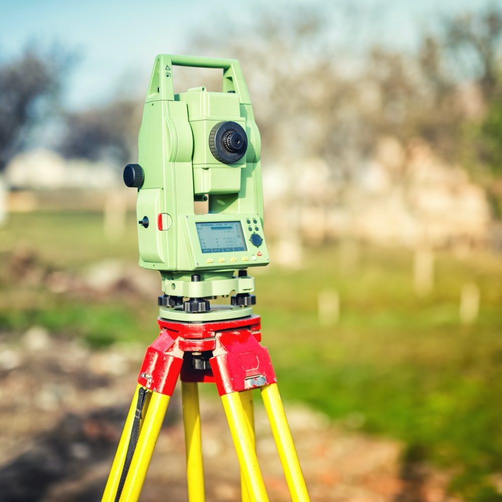 surveyor engineering equipment with theodolite and total station at a construction site